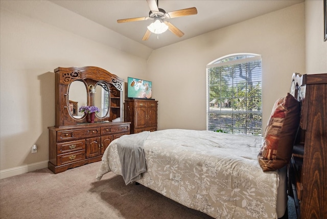 bedroom with ceiling fan, lofted ceiling, and light colored carpet