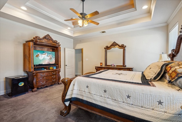 carpeted bedroom with ornamental molding, a raised ceiling, and ceiling fan