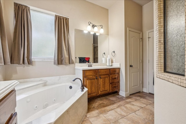 bathroom with vanity, a relaxing tiled tub, and a healthy amount of sunlight