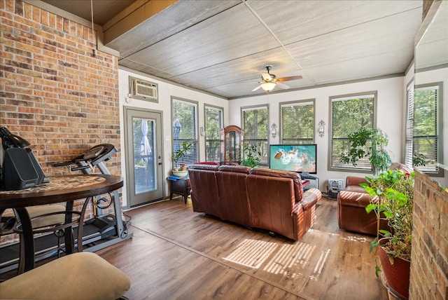 interior space featuring a wall unit AC and ceiling fan