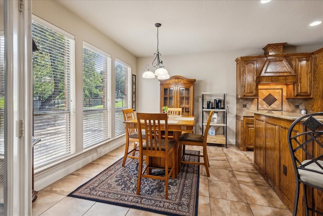 tiled dining space with a notable chandelier and a wealth of natural light