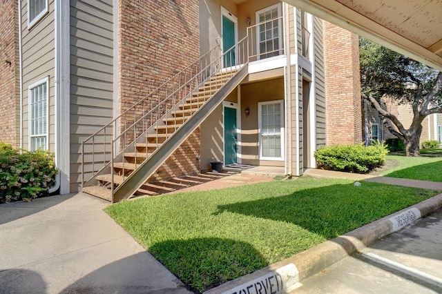 doorway to property featuring a yard