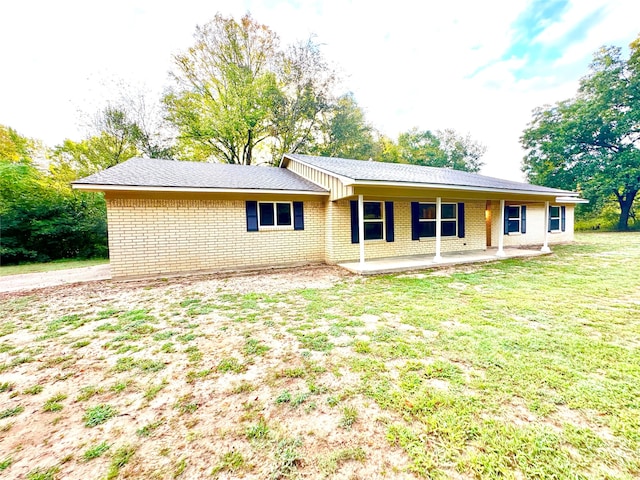 back of property featuring a lawn