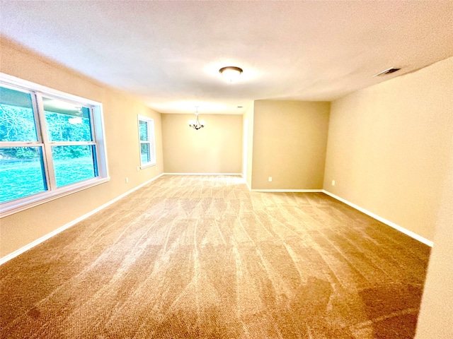 spare room featuring a textured ceiling and carpet floors