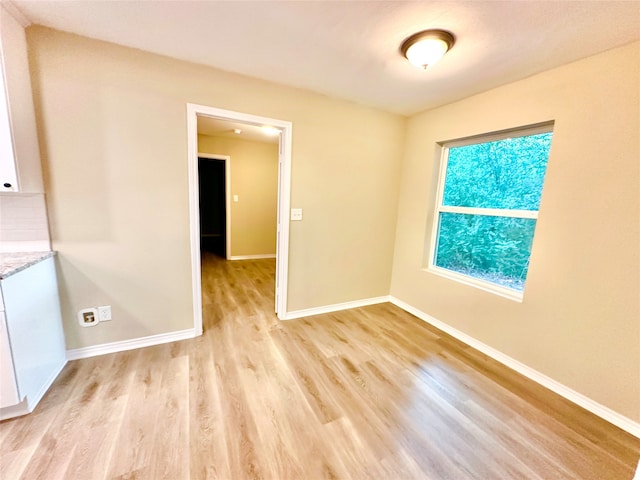 spare room featuring light hardwood / wood-style floors