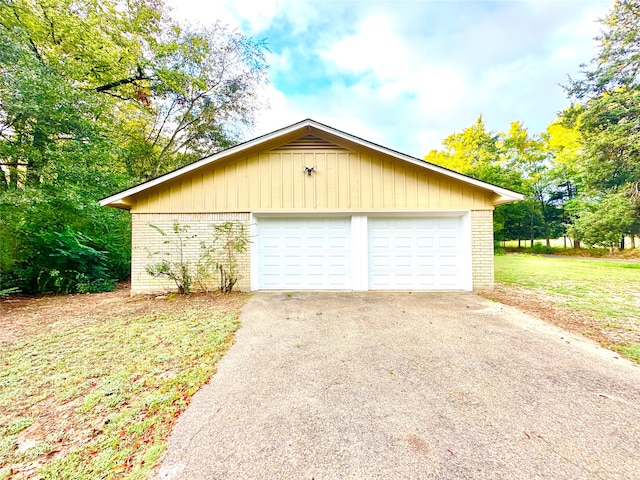 garage with wood walls and a yard