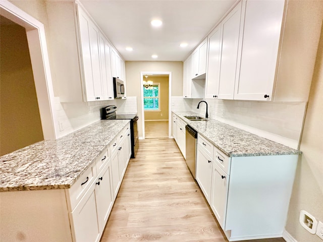 kitchen featuring light hardwood / wood-style floors, stainless steel appliances, sink, and white cabinets