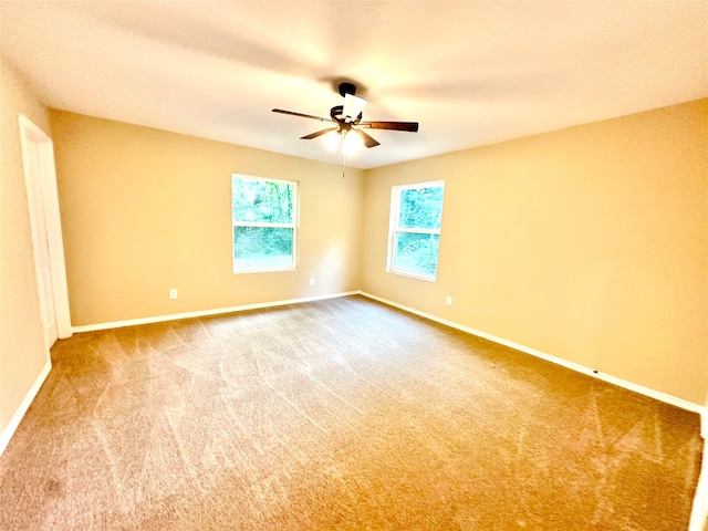 empty room with carpet floors and ceiling fan