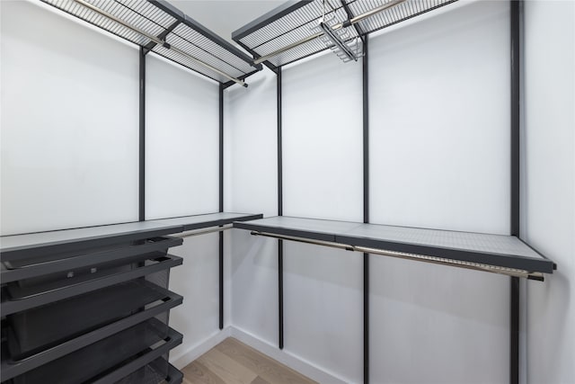 walk in closet featuring light hardwood / wood-style floors