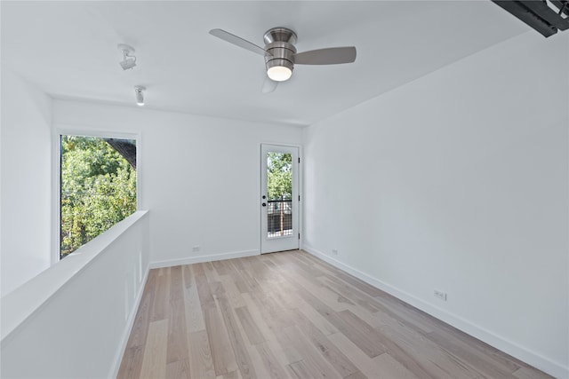 spare room featuring light hardwood / wood-style flooring and ceiling fan