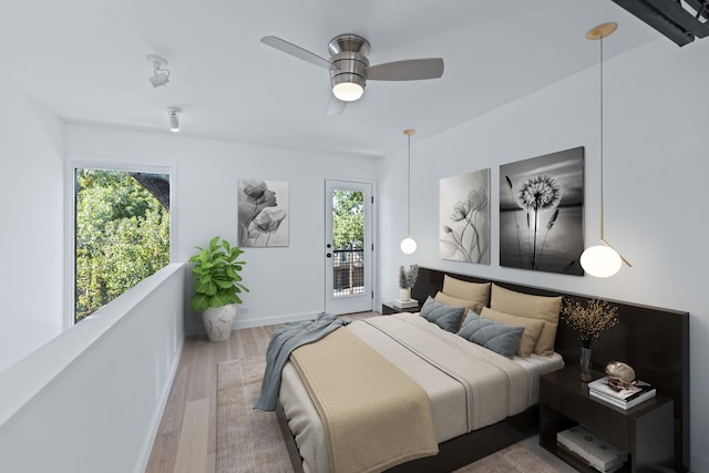 bedroom with access to exterior, hardwood / wood-style flooring, and ceiling fan