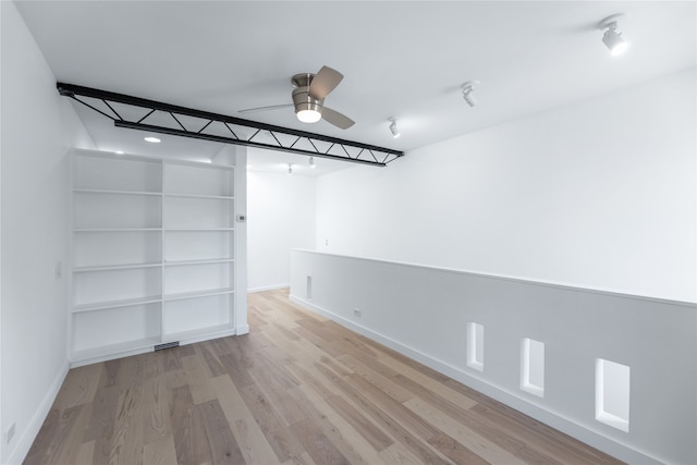 basement with ceiling fan and wood-type flooring