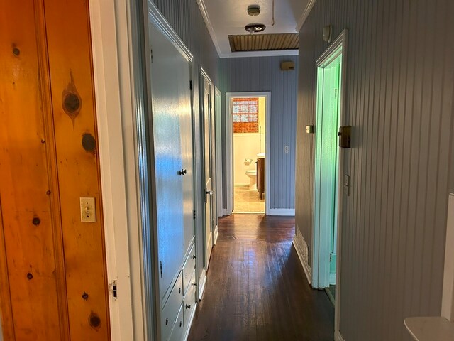 hall with crown molding and dark hardwood / wood-style flooring