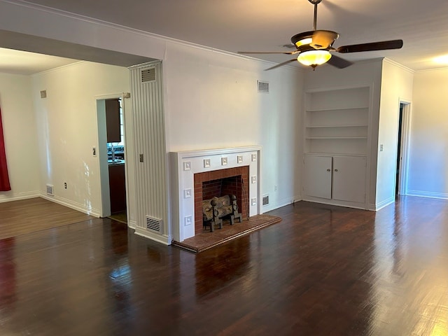 unfurnished living room with built in features, ornamental molding, ceiling fan, and dark hardwood / wood-style floors