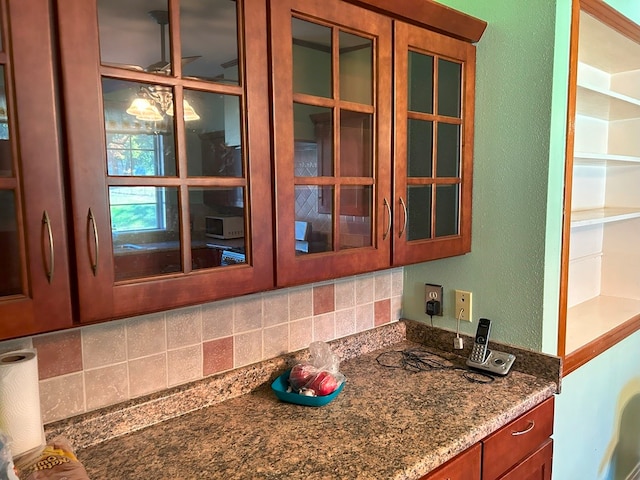 kitchen with tasteful backsplash and stone countertops