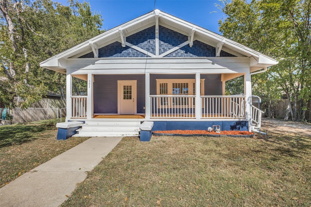 view of front of property with a front yard and a porch