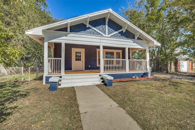 bungalow-style house featuring a porch and a front lawn