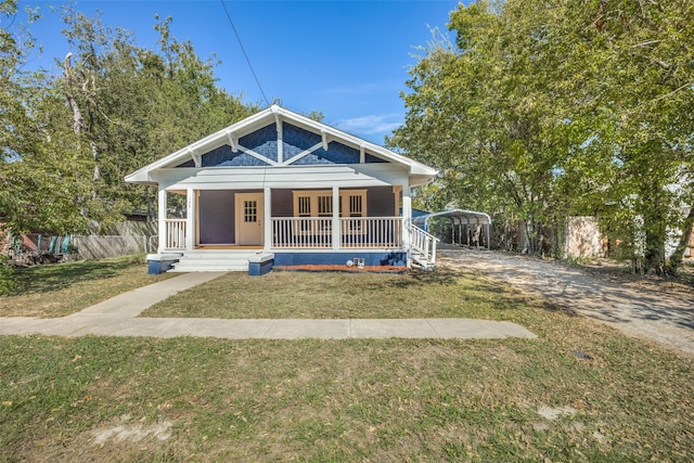 view of front facade with covered porch and a front yard