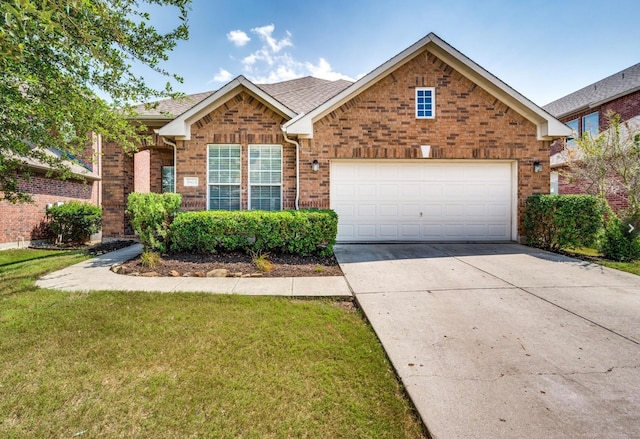 view of front of home with a garage and a front lawn