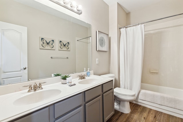 full bathroom with vanity, toilet, hardwood / wood-style flooring, and shower / bath combo