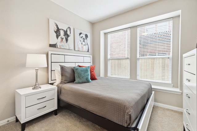 carpeted bedroom with multiple windows