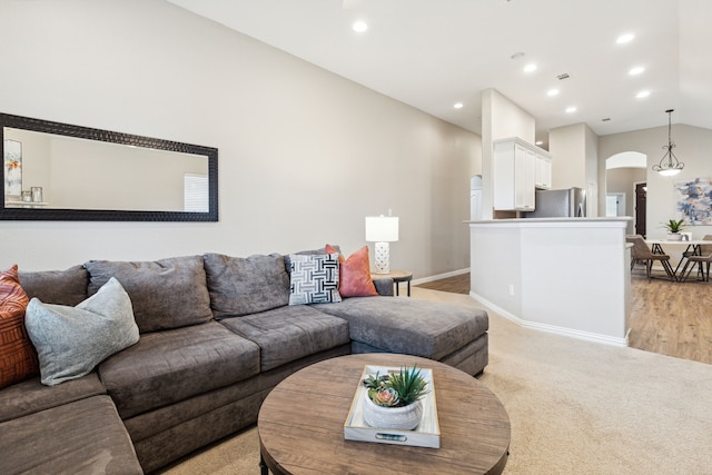 living room with light hardwood / wood-style floors and lofted ceiling