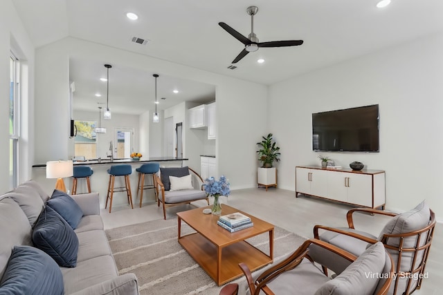 living room featuring a ceiling fan, recessed lighting, visible vents, and vaulted ceiling