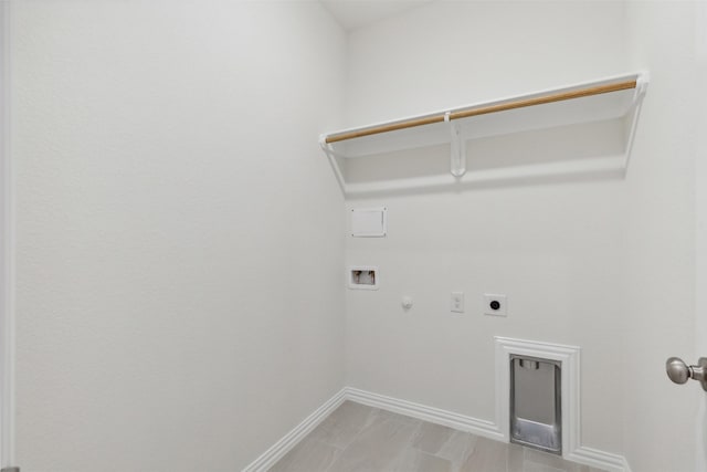 clothes washing area featuring hookup for a washing machine, hookup for a gas dryer, laundry area, baseboards, and electric dryer hookup