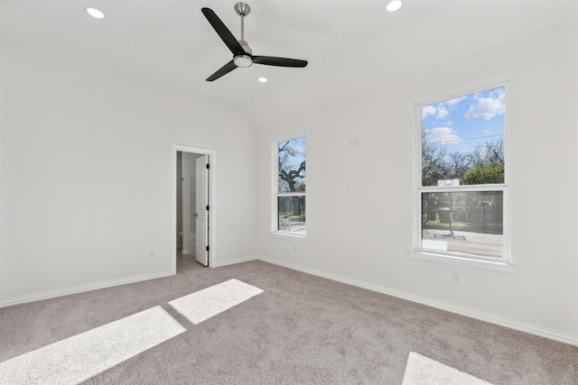 spare room with recessed lighting, light carpet, vaulted ceiling, ceiling fan, and baseboards