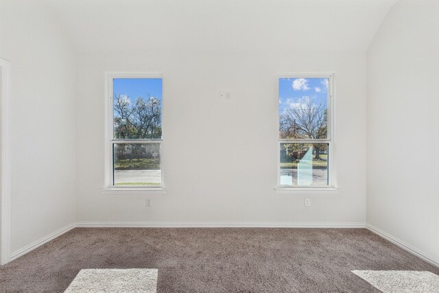 unfurnished room featuring ceiling fan, plenty of natural light, light carpet, and lofted ceiling