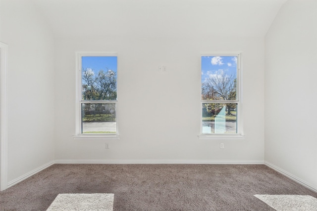 carpeted empty room featuring baseboards