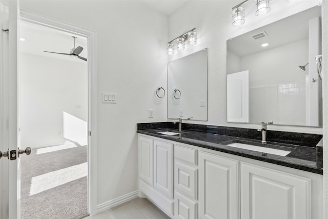 bathroom with tile patterned floors, visible vents, a sink, and double vanity