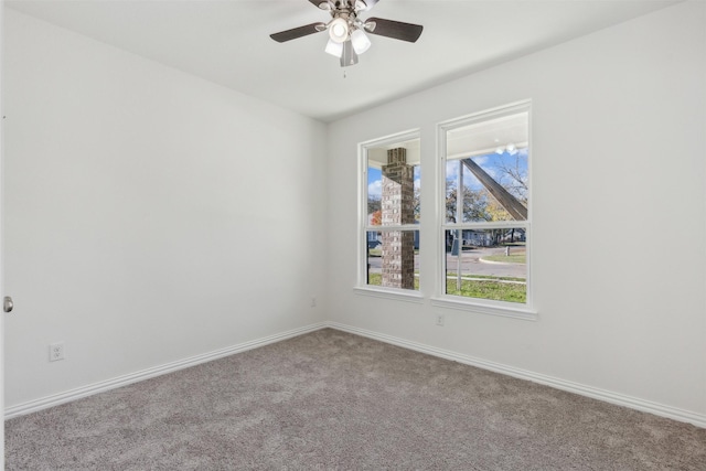 unfurnished room featuring a ceiling fan, light colored carpet, and baseboards