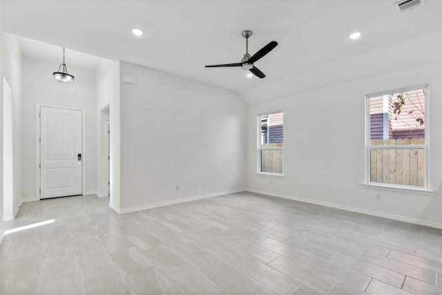 unfurnished room featuring ceiling fan with notable chandelier