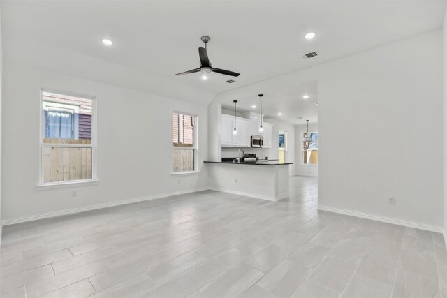 living room featuring ceiling fan and sink