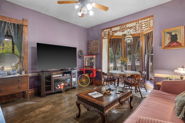 living room with dark wood-type flooring and ceiling fan