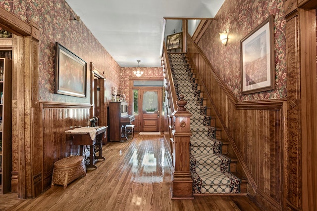 corridor featuring wooden walls and wood-type flooring