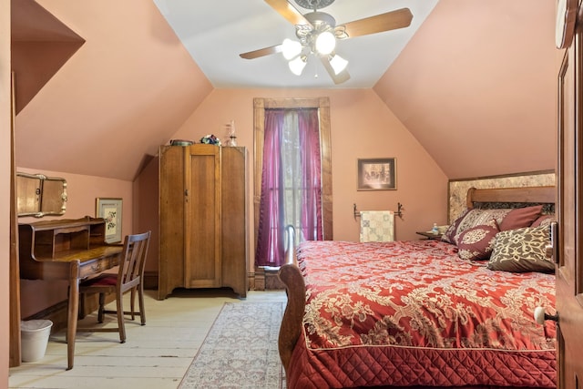 bedroom featuring light hardwood / wood-style flooring, ceiling fan, and vaulted ceiling