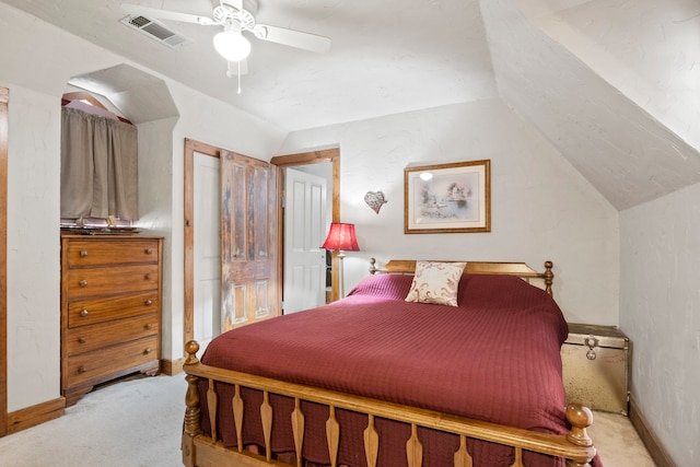 carpeted bedroom with ceiling fan and vaulted ceiling