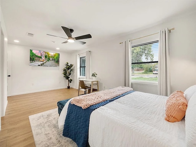 bedroom with ceiling fan and hardwood / wood-style floors