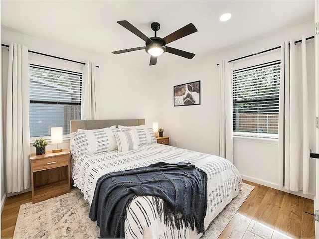 bedroom with light wood-type flooring and ceiling fan