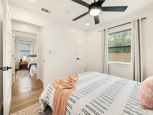 bedroom with ceiling fan and light hardwood / wood-style floors