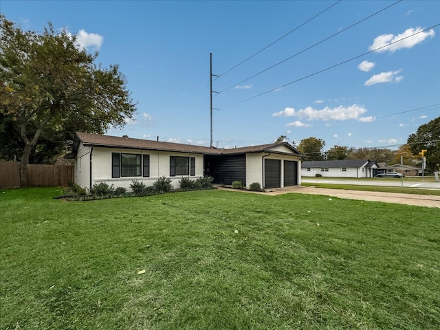 ranch-style home featuring a front lawn and a garage