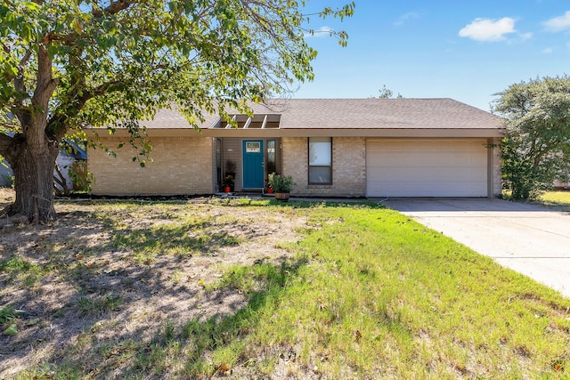 single story home featuring a garage and a front lawn