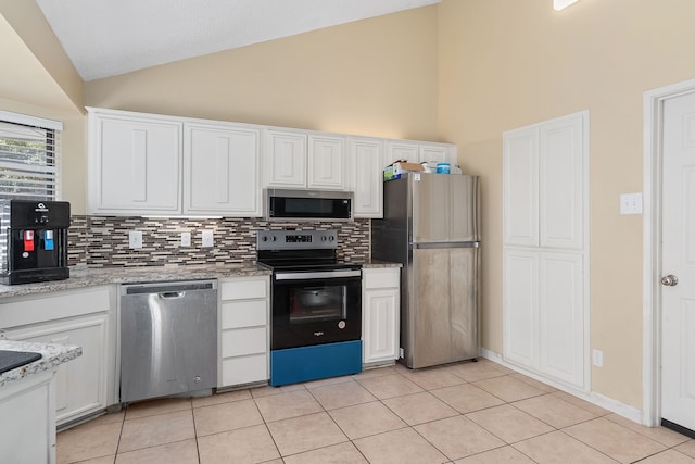 kitchen featuring white cabinetry, light stone counters, stainless steel appliances, and light tile patterned floors