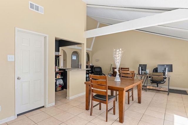 dining room with high vaulted ceiling, beamed ceiling, and light tile patterned floors