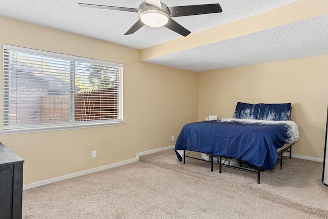 bedroom featuring light carpet, a textured ceiling, and ceiling fan