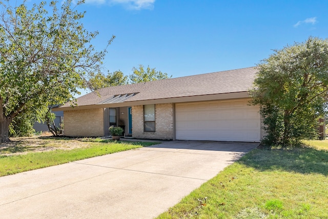 single story home featuring a front yard and a garage