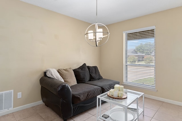 living room featuring a chandelier and light tile patterned flooring