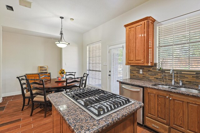 kitchen featuring sink, wood-type flooring, plenty of natural light, and appliances with stainless steel finishes